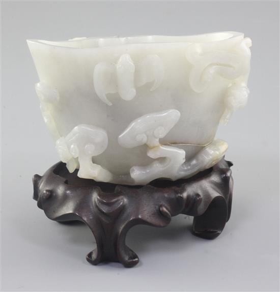 A Chinese greyish-white jade cup or brushwasher, 12cm, wood stand